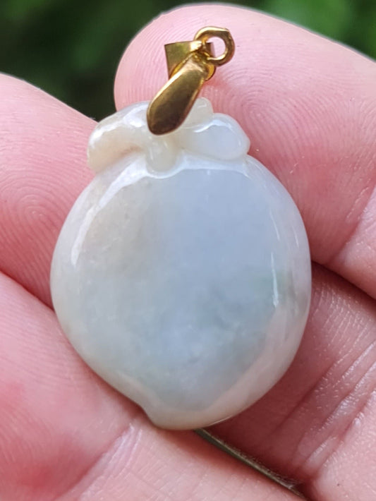 Close-up of a vintage natural Grade A Burmese jadeite pendant in icy bluish, milky white, and moss green carved as a Peach, item JOP007