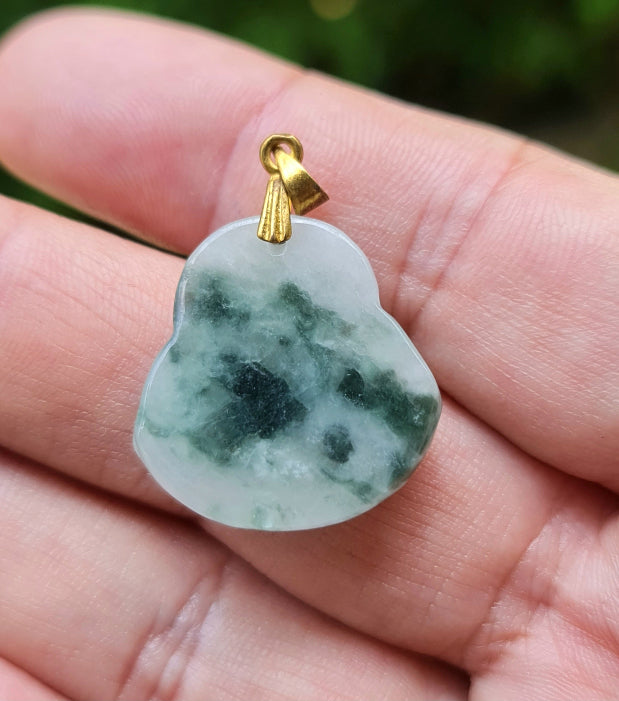 Handcrafted genuine Grade A Burmese jadeite amulet with apple green tones representing wealth and contentment
