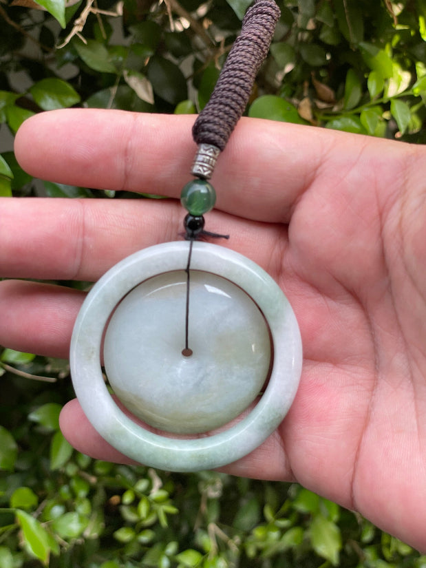 Handcrafted genuine Grade A Burmese jadeite amulet with green and milky white colors representing prosperity and purification