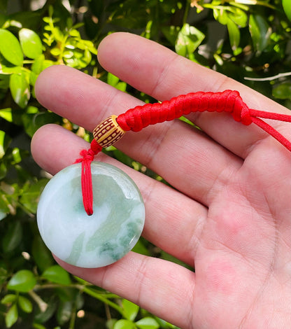 Handcrafted genuine Grade A Burmese jadeite amulet with forest green and white colors representing prosperity and purification