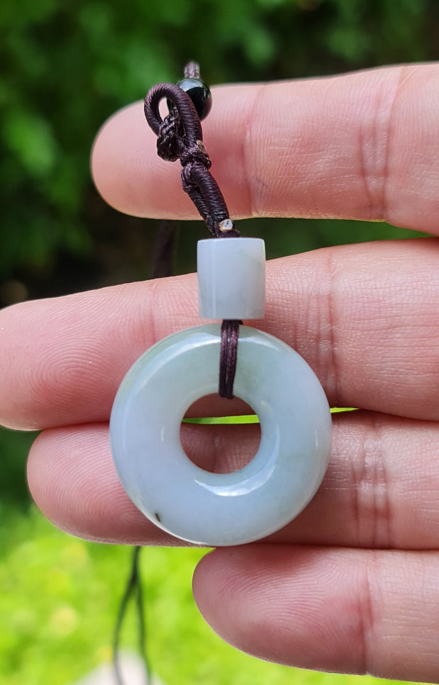 Handcrafted genuine Grade A Burmese jadeite amulet with icy lavender colors representing spiritual growth and inner strength