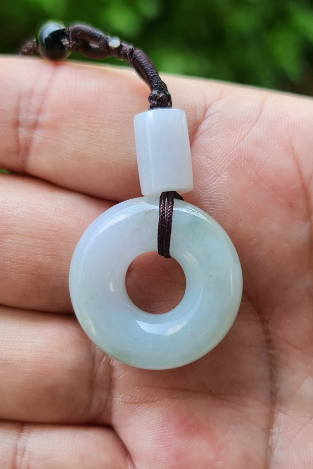 Handcrafted genuine Grade A Burmese jadeite amulet with icy lavender colors representing spiritual growth and inner strength