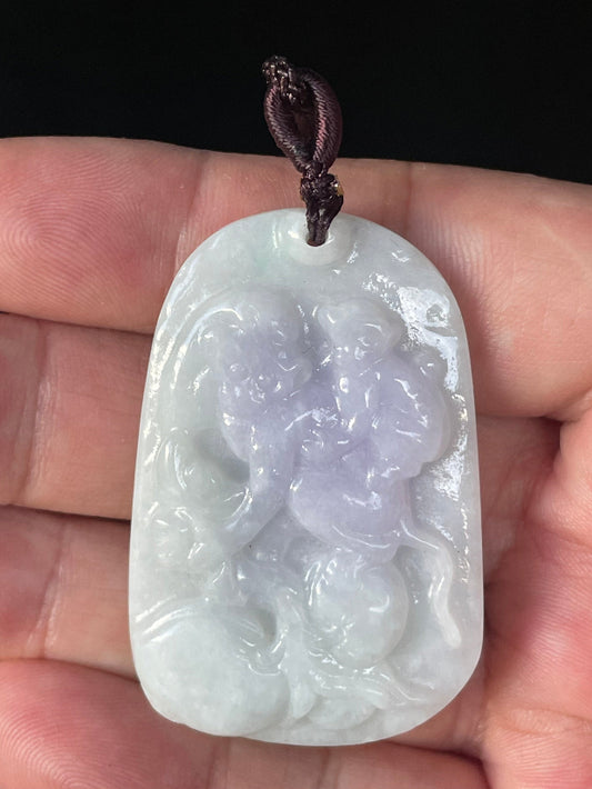 Close-up of a natural Grade A Burmese jadeite pendant featuring icy milky white and lavender hues hand-carved with a two monkeys motif, item JP021