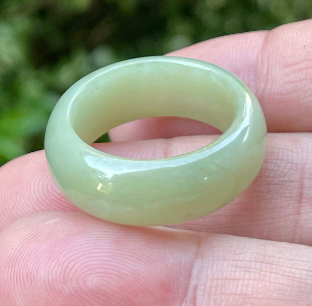 Close-up of a large round natural Grade A Burmese jadeite ring featuring icy apple green and honey hues, item JRN043