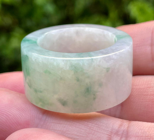 Hand-carved genuine Grade A Burmese jadeite wide band showcasing striking translucency and imperial green swirls