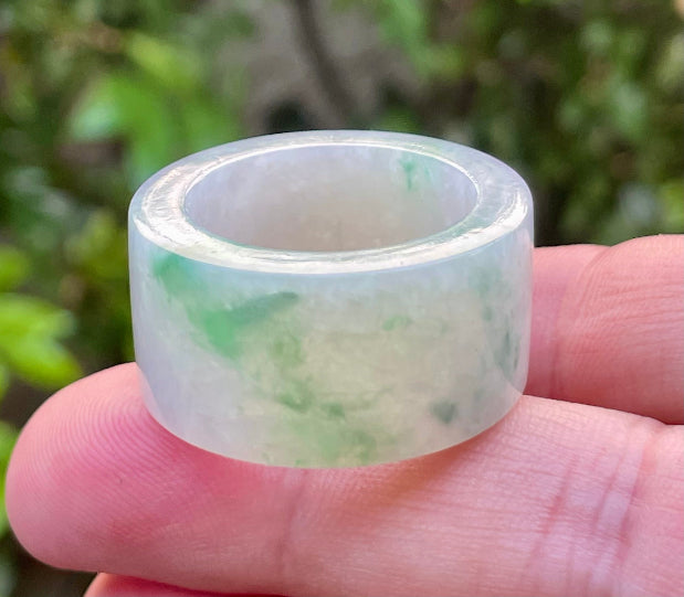 Hand-carved genuine Grade A Burmese jadeite wide band showcasing striking translucency and imperial green swirls