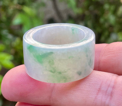 Hand-carved genuine Grade A Burmese jadeite wide band showcasing striking translucency and imperial green swirls