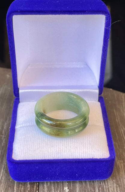 Hand-carved genuine Grade A Burmese jadeite ring showcasing a raised central groove and icy imperial green color
