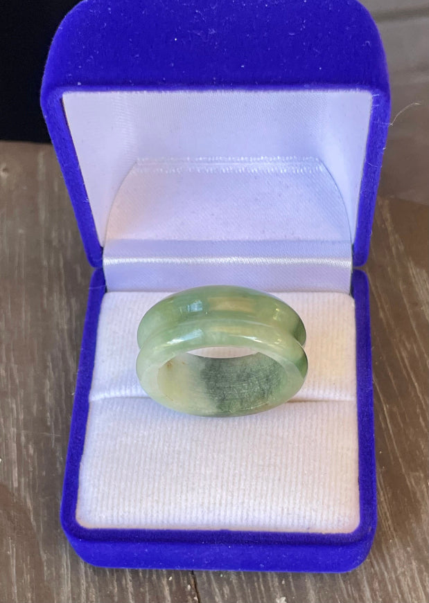 Hand-carved genuine Grade A Burmese jadeite ring showcasing a raised central groove and icy imperial green color