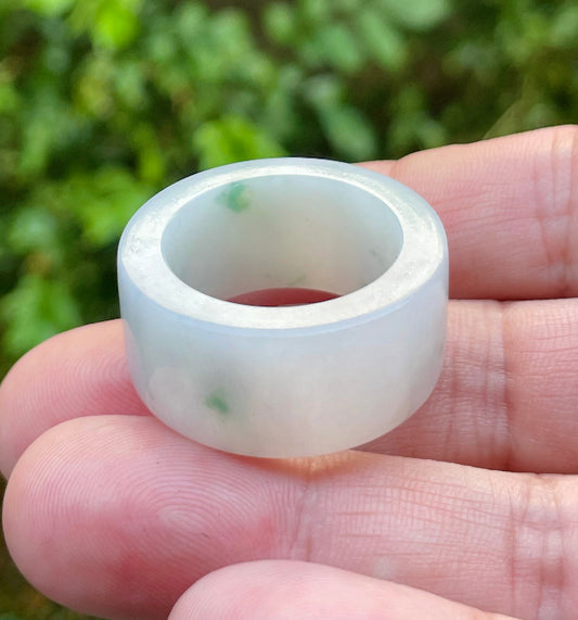 Close-up of a wide tube thumb band natural Grade A Burmese jadeite ring featuring icy milky white and imperial green hues, item JRN024