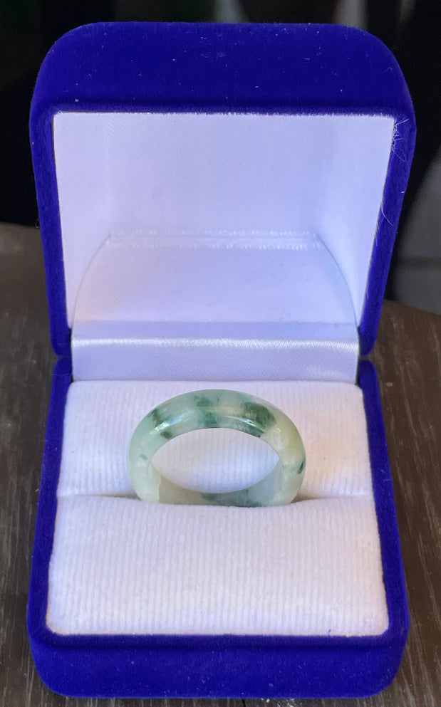 Close-up of a single bangle-style natural Grade A Burmese jadeite ring featuring moss in snow coloration, item JR119