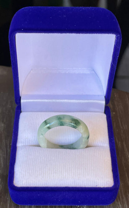 Close-up of a single bangle-style natural Grade A Burmese jadeite ring featuring moss in snow coloration, item JR119