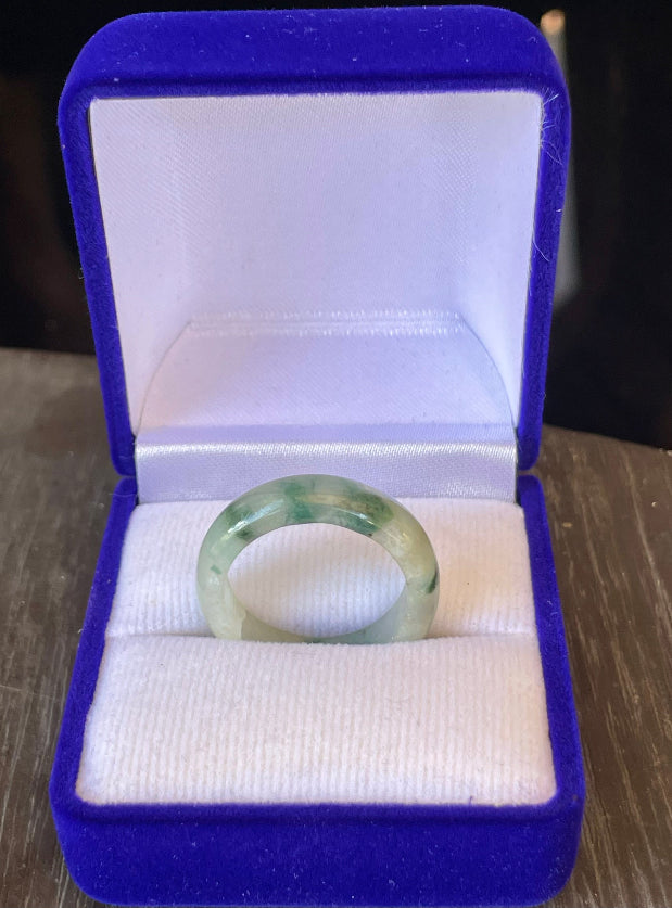 Hand-carved genuine Grade A Burmese jadeite ring showcasing vibrant mossy green hues on an icy white base