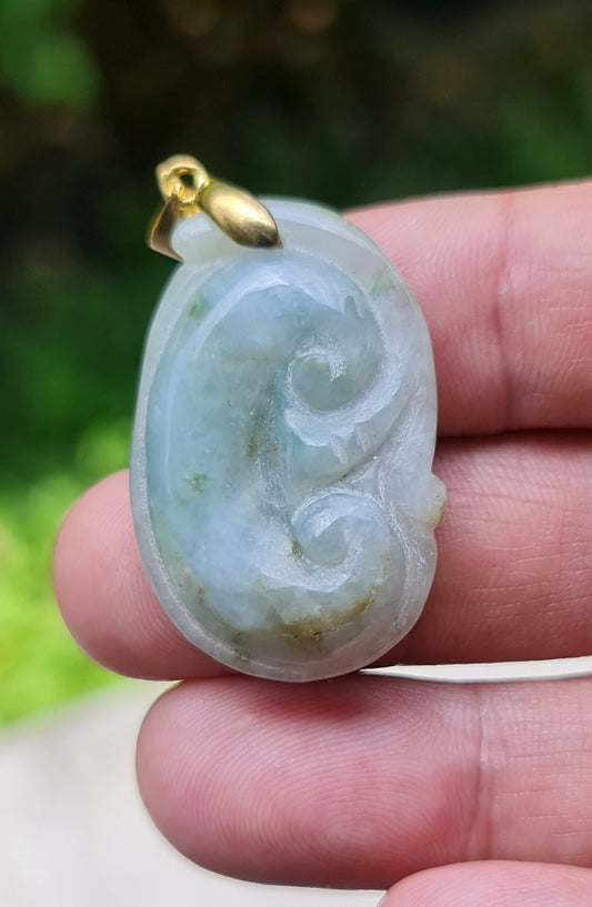 Close-up of a vintage natural Grade A Burmese jadeite pendant in bluish milky white carved as a Ruyi Swirl, item JOP002