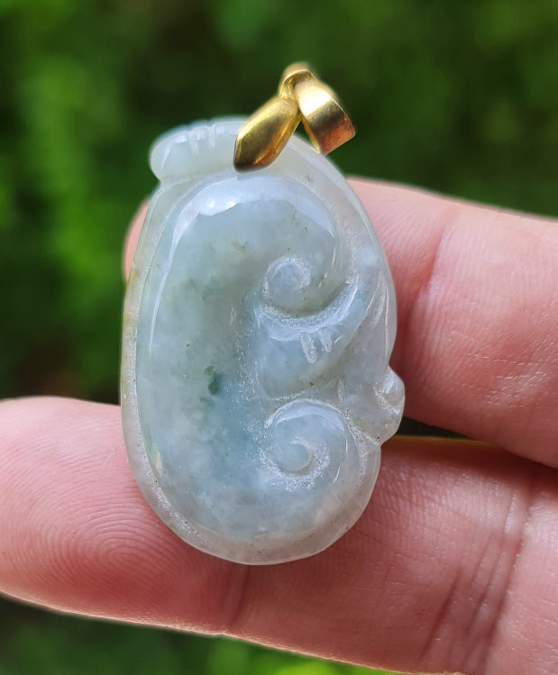 Close-up of a vintage natural Grade A Burmese jadeite pendant in icy bluish moss green carved as a Ruyi Swirl, item JOP006