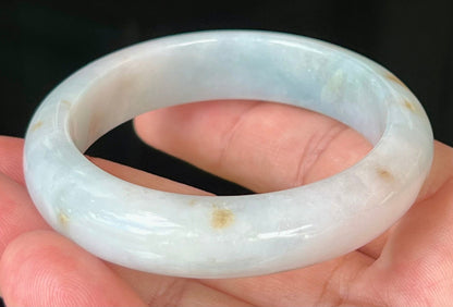 Close-up of honey brown hues on icy bluish milky white jadeite bangle