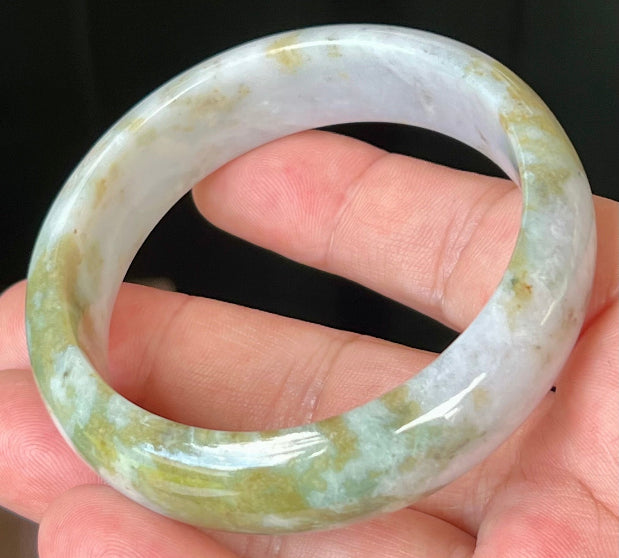 Close-up of apple moss green accents on icy grey jadeite bangle
