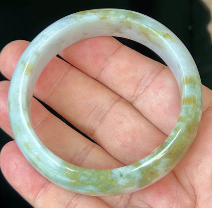 Close-up of apple moss green accents on icy grey jadeite bangle