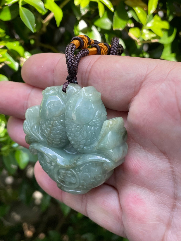 Handcrafted genuine Grade A certified Burmese jadeite amulet with bluish moss green colors representing wealth and mental clarity
