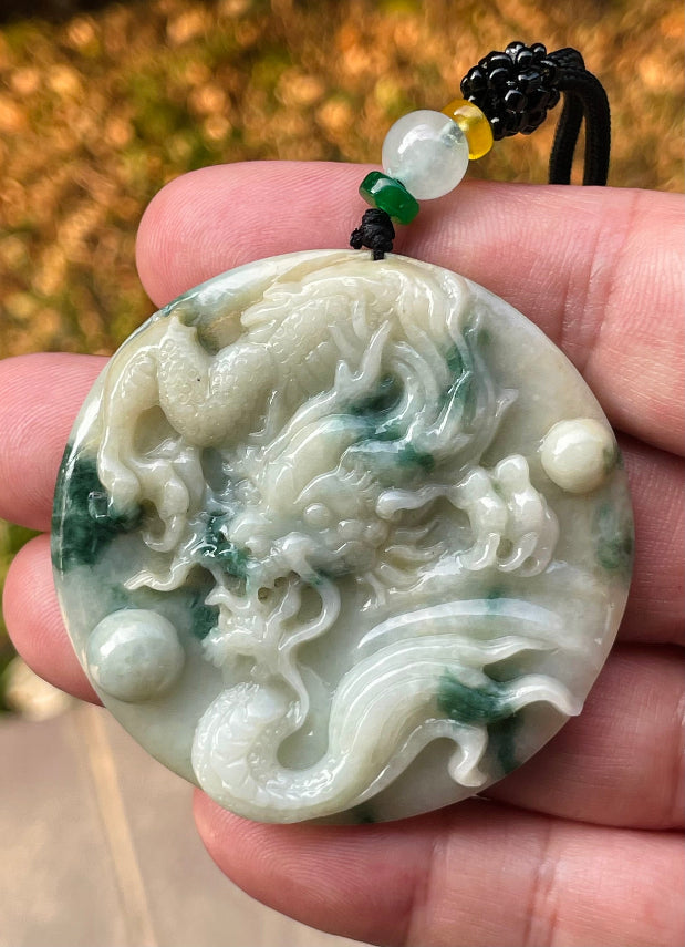 Handcrafted genuine Grade A certified Burmese jadeite amulet with green and milky white colors representing prosperity and purification