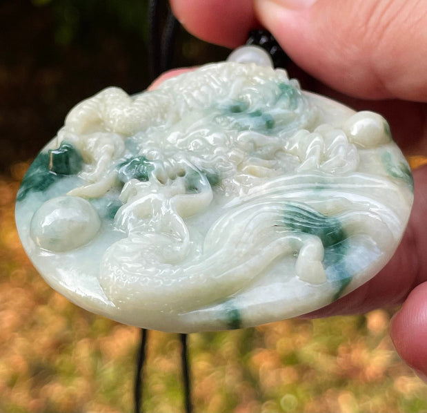 Handcrafted genuine Grade A certified Burmese jadeite amulet with green and milky white colors representing prosperity and purification