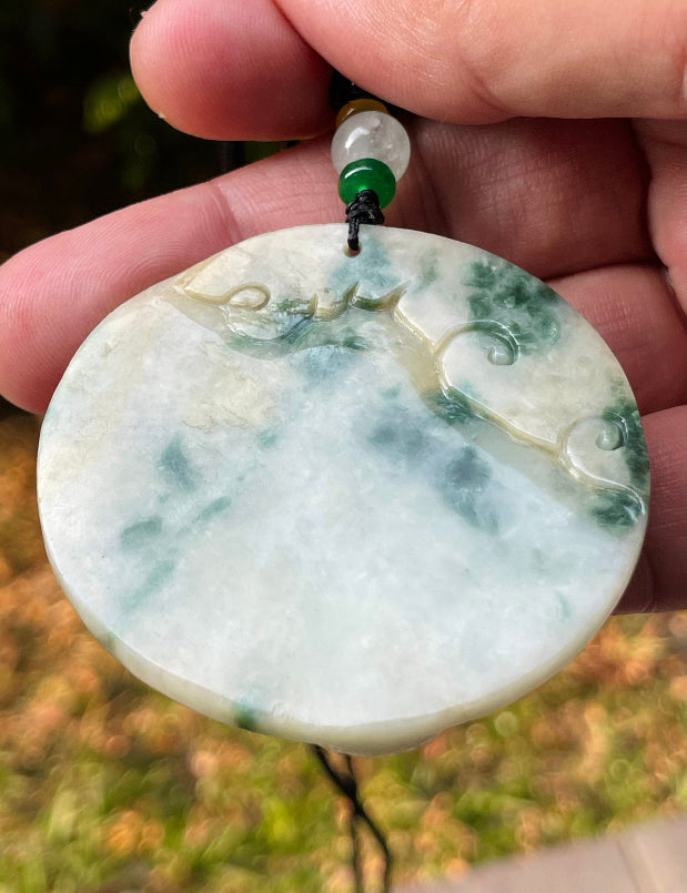 Handcrafted genuine Grade A certified Burmese jadeite amulet with green and milky white colors representing prosperity and purification