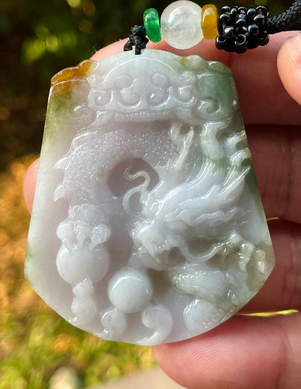 Handcrafted genuine Grade A certified Burmese jadeite amulet with green and milky white colors representing prosperity and purification