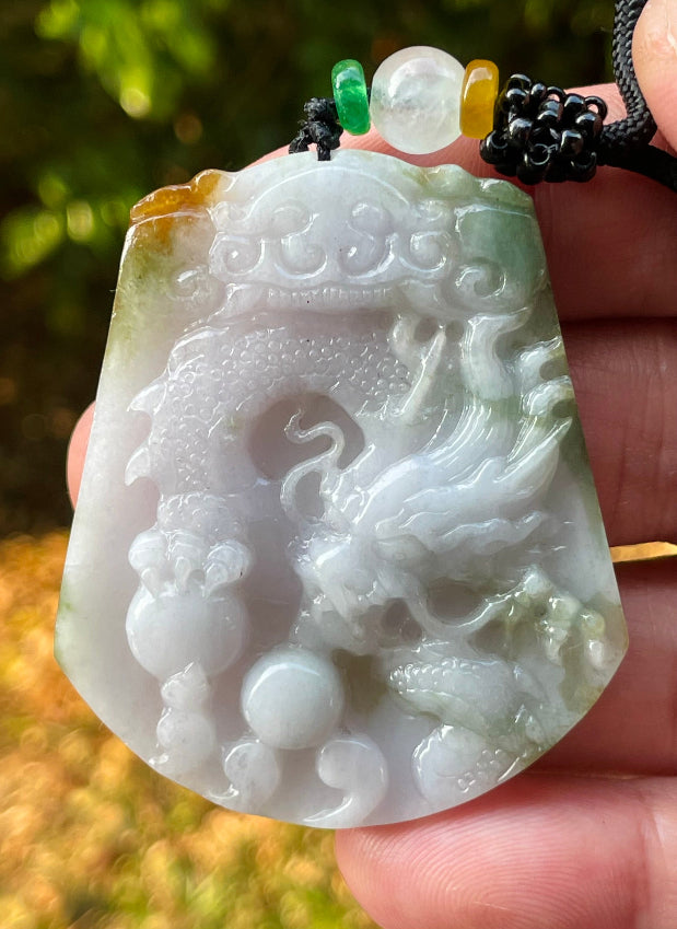 Handcrafted genuine Grade A certified Burmese jadeite amulet with green and milky white colors representing prosperity and purification