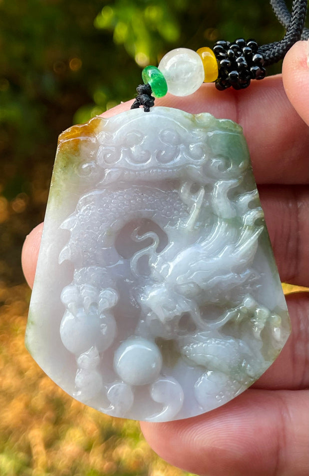Handcrafted genuine Grade A certified Burmese jadeite amulet with green and milky white colors representing prosperity and purification