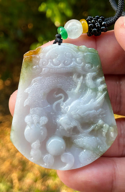 Handcrafted genuine Grade A certified Burmese jadeite amulet with green and milky white colors representing prosperity and purification