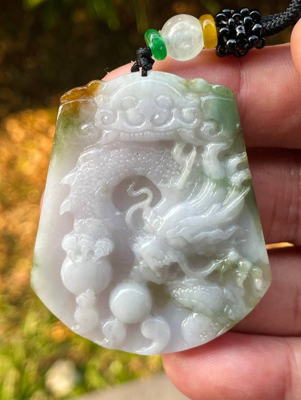 Handcrafted genuine Grade A certified Burmese jadeite amulet with green and milky white colors representing prosperity and purification