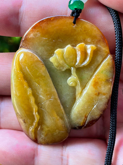 Handcrafted genuine Grade A certified Burmese jadeite amulet with orange and olive green colors representing warmth and prosperity