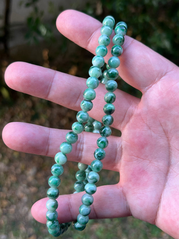 Soft glassy luster and fine crystalline texture of the 6.8mm authentic Myanmar jadeite bead necklace JN088