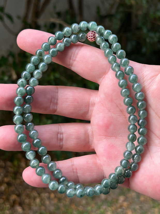 Soft glassy luster and fine crystalline texture of the 6.4mm authentic Myanmar jadeite bead necklace JN092
