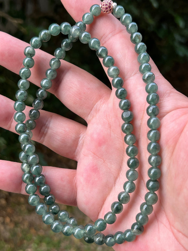 Soft glassy luster and fine crystalline texture of the 6.4mm authentic Myanmar jadeite bead necklace JN092