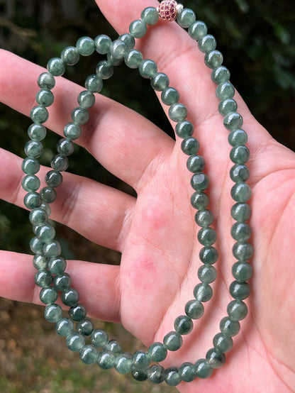 Soft glassy luster and fine crystalline texture of the 6.4mm authentic Myanmar jadeite bead necklace JN092
