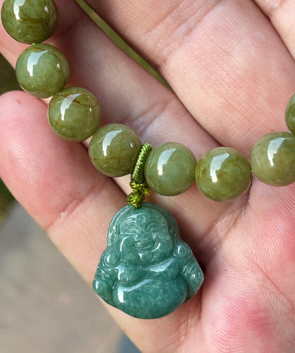 9mm natural Type A Burmese jade beads showing earthy olive green hues and a hand-carved Laughing Buddha pendant on the wrist