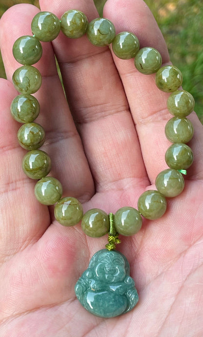 9mm natural Type A Burmese jade beads showing earthy olive green hues and a hand-carved Laughing Buddha pendant on the wrist