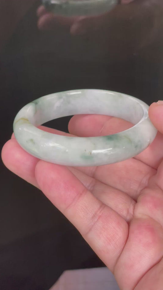 Video showcasing the vitreous luster and fine crystalline texture of rare icy grayish milky white, imperial green, and apple green Burmese jadeite bangle JB824