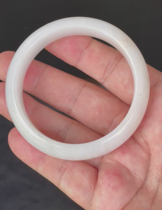Video showcasing the vitreous luster and fine crystalline texture of icy milky white and delicate honey Burmese jadeite bangle JB827