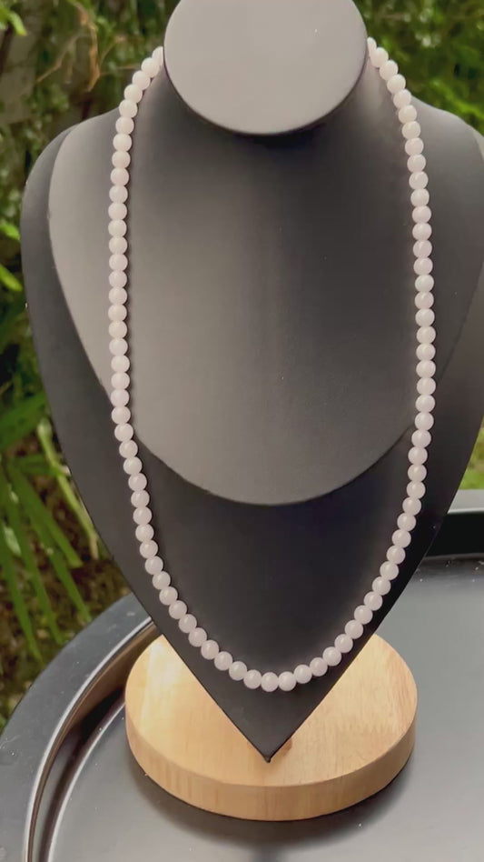 Video showcasing the soft glassy luster and elegant icy milky white and light apple green color palette of the 6.3mm certified Burmese jade bead necklace JN016