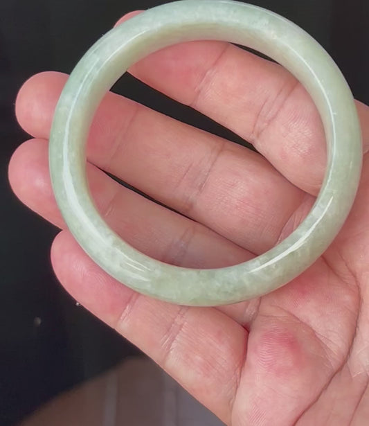 Video showcasing the natural glassy luster and fine crystalline texture of icy apple green and milky white Burmese jadeite bangle JB537