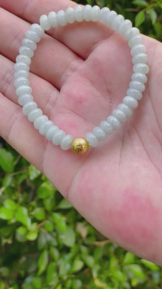 Video showcasing the vitreous luster, icy apple green hue, and matte gold-tone accent of the 7.5mm Burmese jade bead bracelet JBB169