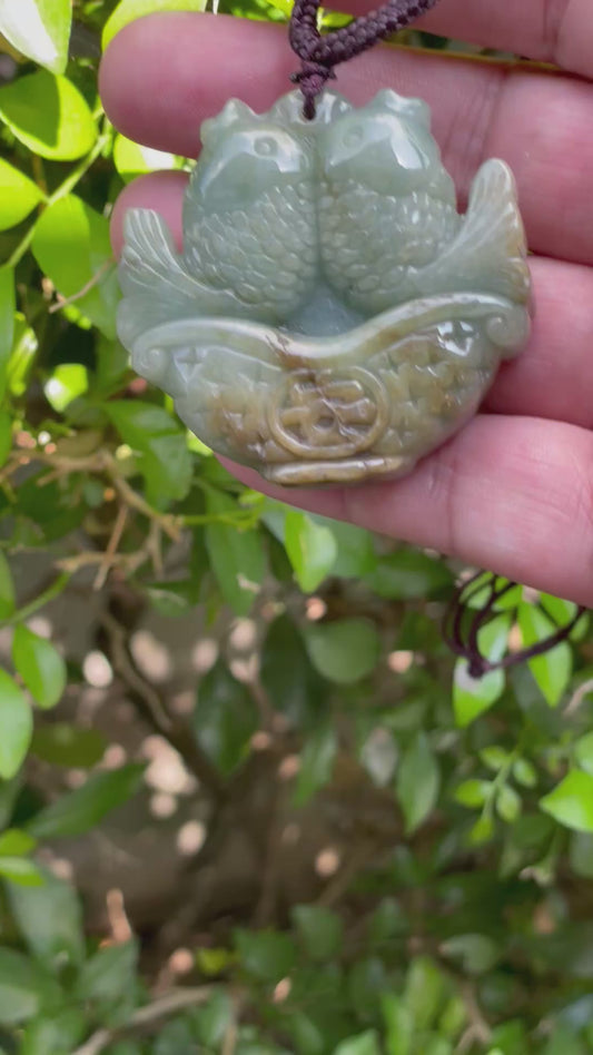 Video showcasing the vitreous luster, bluish moss green hues, and hand-carved twin fish in a treasure basket motif of the certified Burmese jade pendant JP037