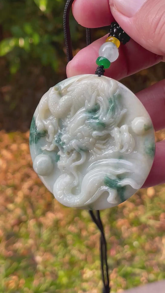 Video showcasing the vitreous luster, green and milky white hues, and hand-carved dragon motif of the certified Burmese jade pendant JP082