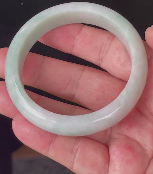 Video showcasing the vitreous luster and fine crystalline texture of icy imperial green, apple green, and milky white Burmese jadeite bangle JB875