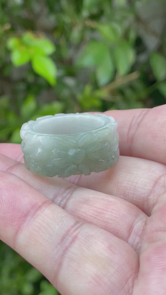 Video showcasing the intricate hand-carved floral motif and natural icy apple green hues of the wide thumb Burmese jadeite ring JRN040