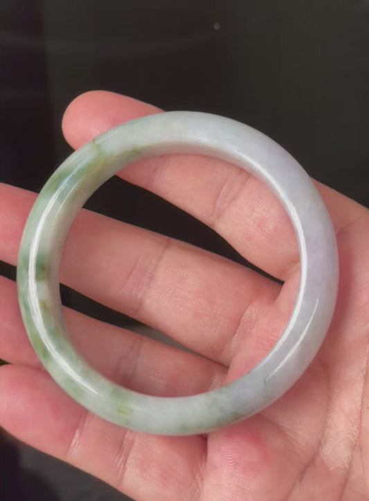 Video showcasing the natural glassy luster and fine crystalline texture of icy imperial and apple green, milky white, and light lavender Burmese jadeite bangle JB216