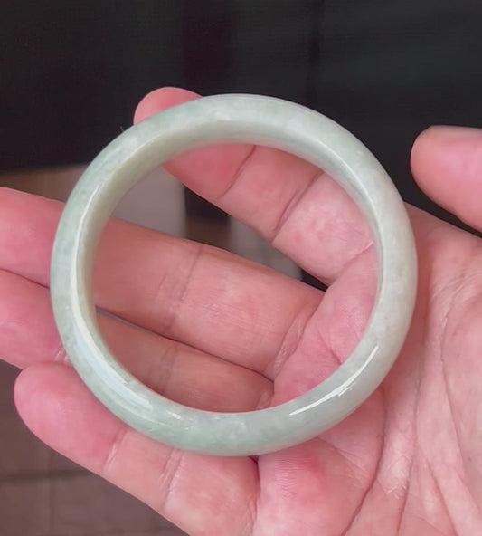 Video showcasing the natural glassy luster and fine crystalline texture of icy apple green and milky white Burmese jadeite bangle JB548