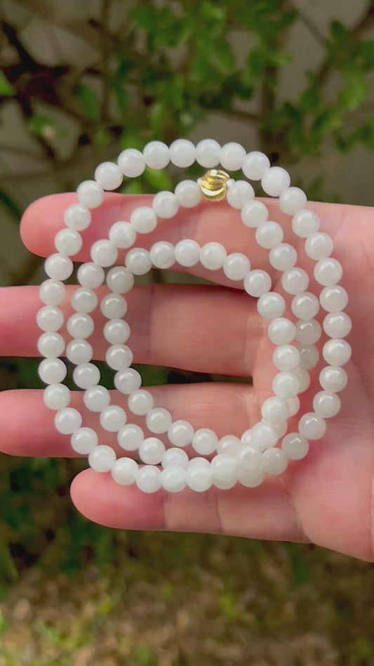 Video showcasing the soft glassy luster and elegant icy milky white and light apple green color palette of the 6.8mm certified Burmese jade bead necklace JN012